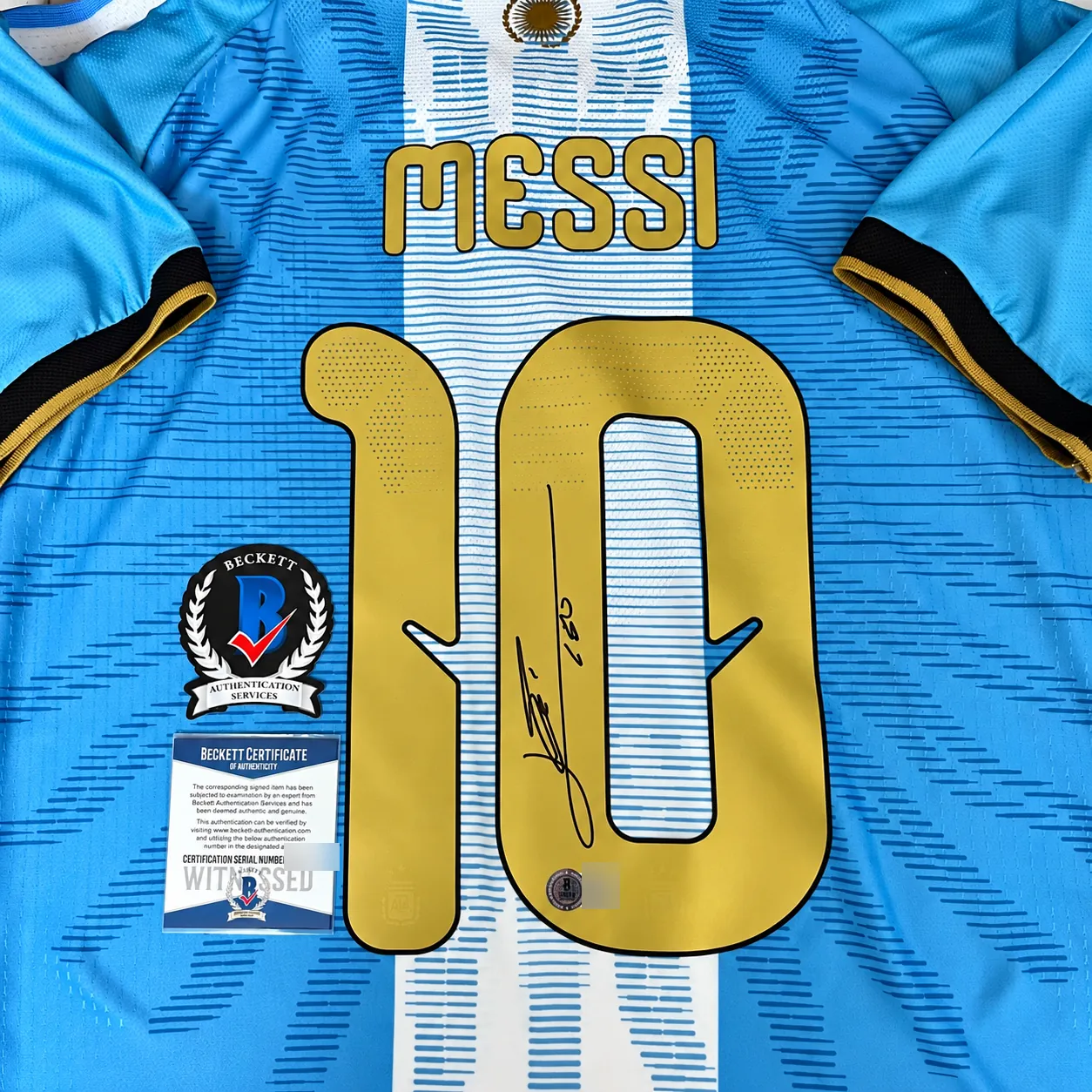 Signed shirt with the Beckett badge and Witnessed certificate laid beside the 10