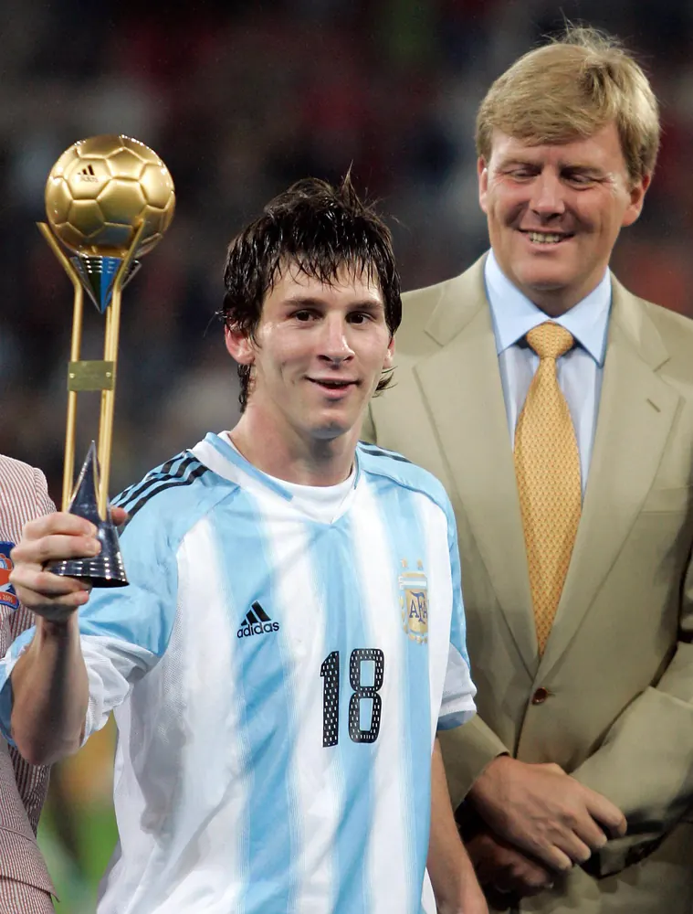 A teenage Messi in the number 18 shirt holding the Golden Ball trophy in 2005